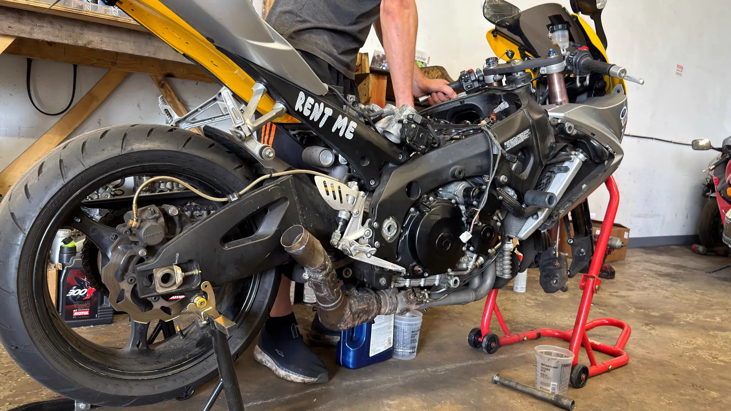 Mechanic working on a sportbike engine at TT Sport Garage